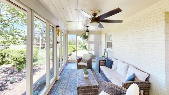 sunroom featuring ceiling fan and wood ceiling