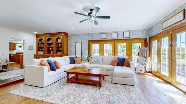 living room with french doors, crown molding, and wood-type flooring