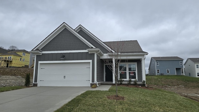 view of front of home with a garage and a front lawn