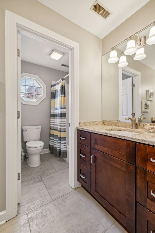 bathroom with tile patterned floors, vanity, and toilet