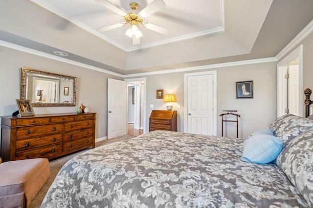 carpeted bedroom featuring a raised ceiling, ceiling fan, and crown molding