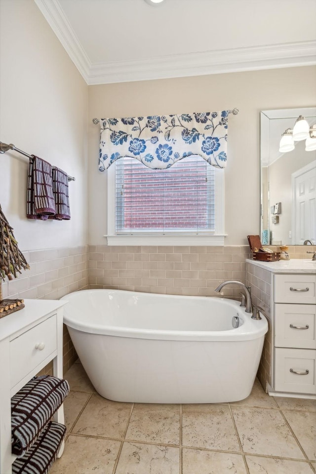 bathroom with vanity, tile patterned floors, a washtub, ornamental molding, and tile walls