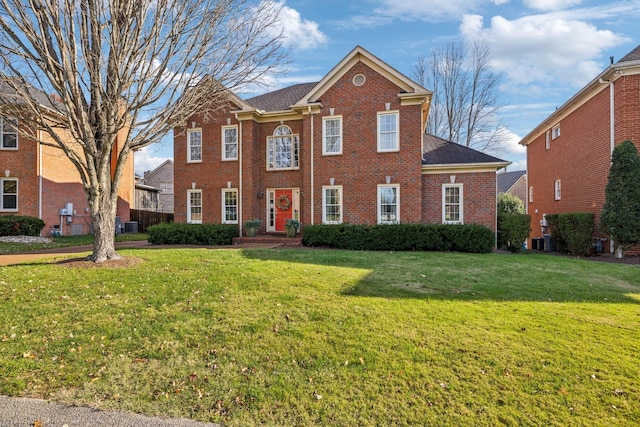 view of front of home featuring a front yard and central AC unit