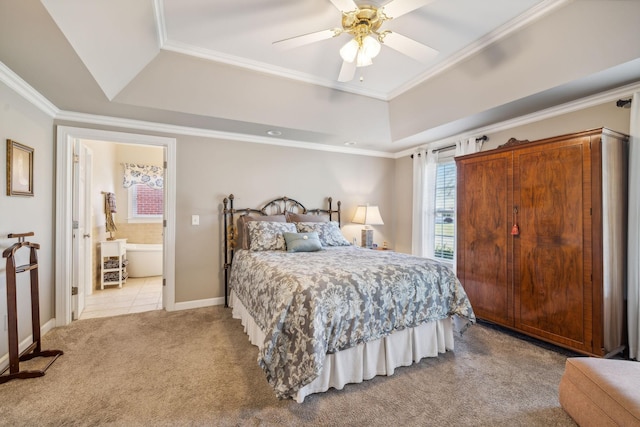 bedroom featuring a tray ceiling, ensuite bath, ceiling fan, and light colored carpet