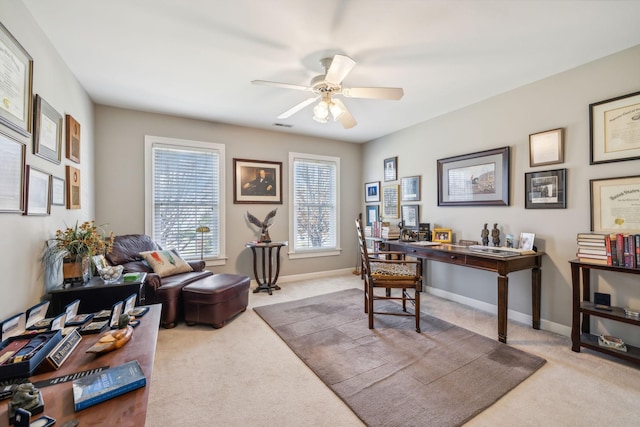 carpeted office space featuring ceiling fan