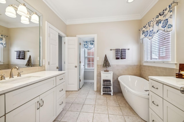 bathroom with vanity, tile patterned floors, ornamental molding, a tub to relax in, and tile walls