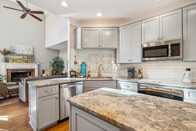 kitchen with gray cabinets, sink, and stainless steel appliances