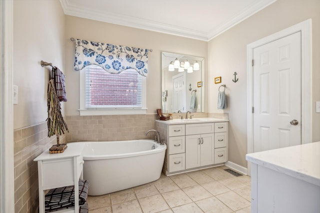 bathroom featuring vanity, a bathtub, crown molding, tile patterned flooring, and tile walls