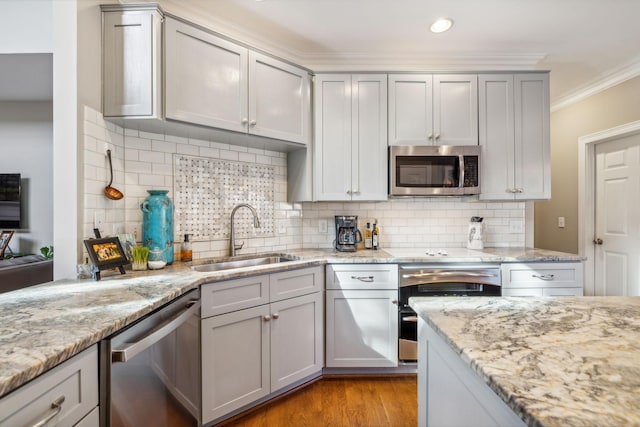 kitchen featuring stainless steel appliances, tasteful backsplash, crown molding, and sink