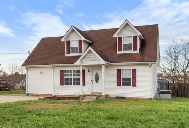 cape cod home with a front lawn