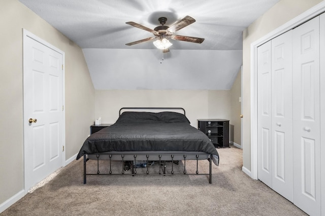 carpeted bedroom with ceiling fan and vaulted ceiling