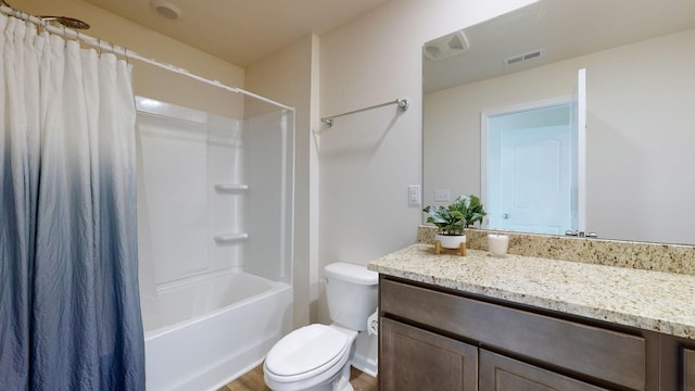 full bathroom with wood-type flooring, vanity, shower / tub combo, and toilet