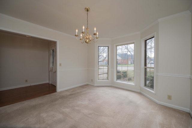 carpeted spare room featuring a notable chandelier and crown molding