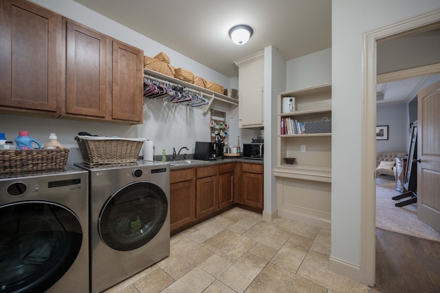 laundry area featuring cabinets, sink, and washing machine and dryer