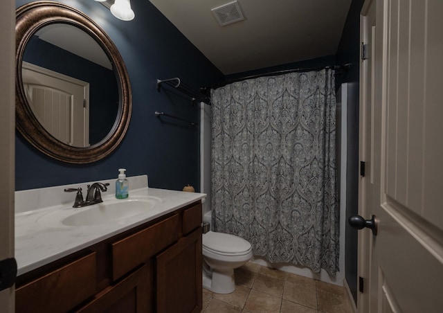 bathroom featuring tile patterned flooring, vanity, and toilet