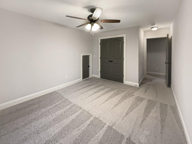 unfurnished bedroom with carpet floors, a closet, and ceiling fan