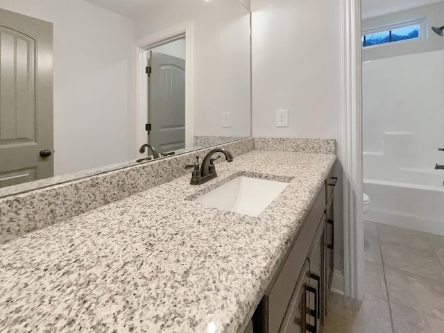 full bathroom featuring washtub / shower combination, tile patterned flooring, vanity, and toilet