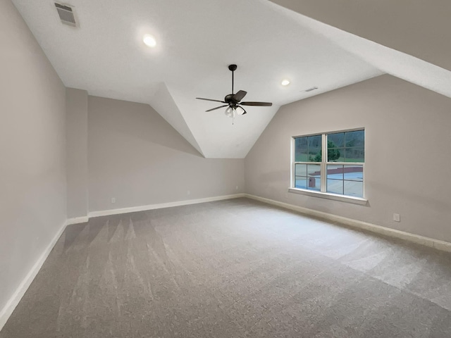 additional living space featuring carpet flooring, vaulted ceiling, and ceiling fan