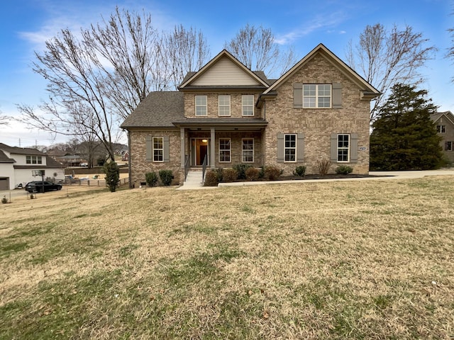 view of front of house featuring covered porch and a front yard