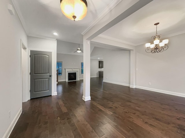 interior space with ceiling fan with notable chandelier, dark hardwood / wood-style flooring, and crown molding