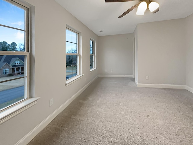 unfurnished room featuring a wealth of natural light and ceiling fan