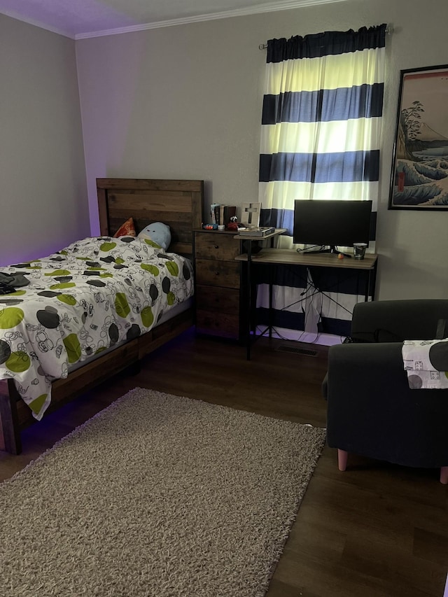 bedroom with hardwood / wood-style floors and crown molding