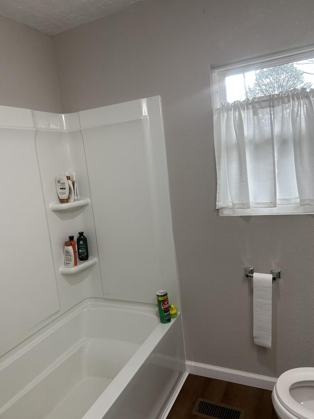 bathroom with hardwood / wood-style floors and toilet