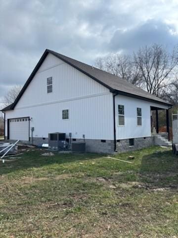 view of property exterior with central AC unit and a lawn