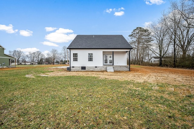 back of property featuring french doors and a yard