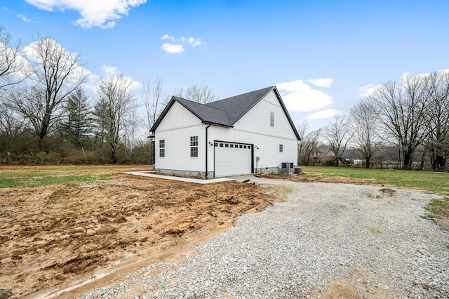 view of property exterior featuring a garage and central air condition unit