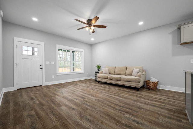 living room featuring dark hardwood / wood-style floors and ceiling fan