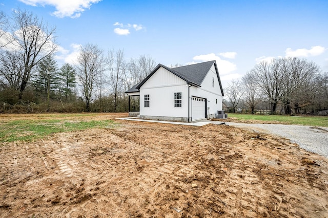 view of property exterior featuring a garage and central AC