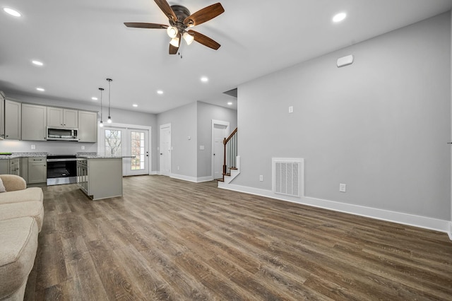 living room featuring ceiling fan and dark hardwood / wood-style flooring