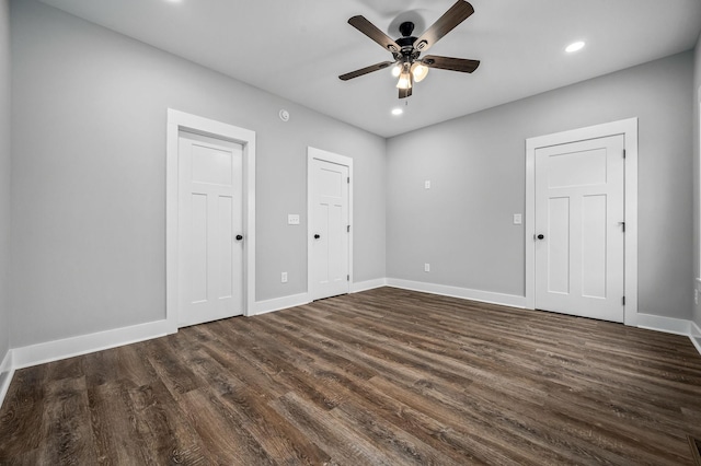 spare room with dark wood-type flooring and ceiling fan