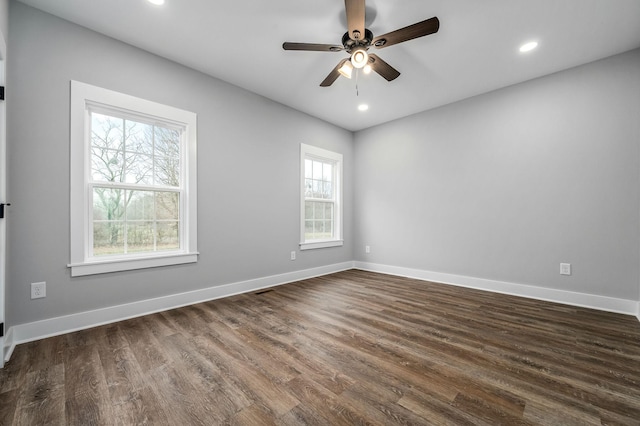 unfurnished room with ceiling fan and dark hardwood / wood-style flooring