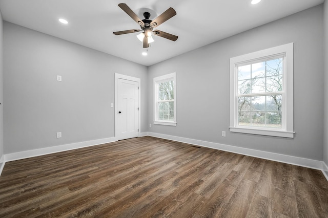 empty room featuring dark hardwood / wood-style floors and ceiling fan