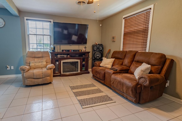 tiled living room with ceiling fan