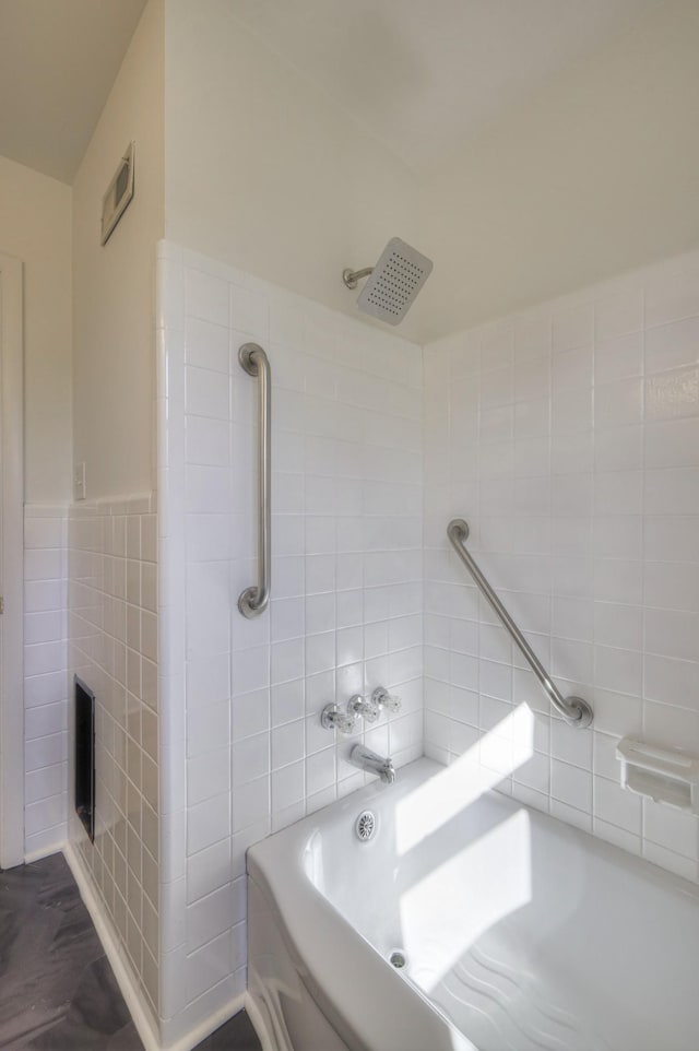 bathroom with tile walls and bathtub / shower combination