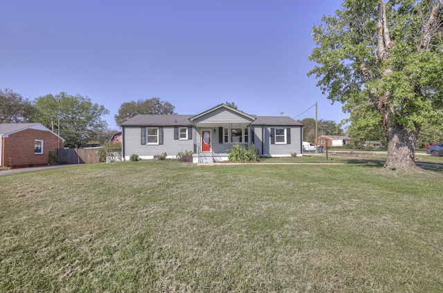 ranch-style house featuring a porch and a front lawn