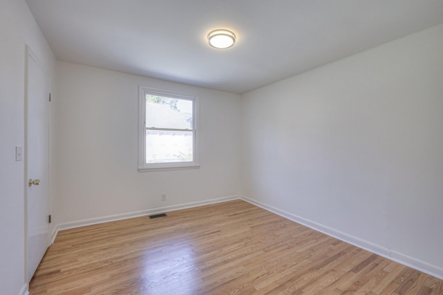 spare room featuring light hardwood / wood-style floors