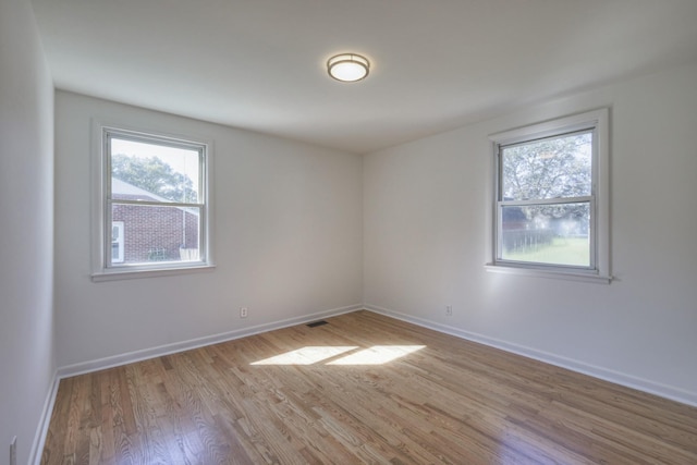 empty room with light hardwood / wood-style flooring