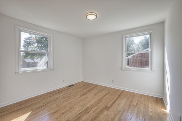 spare room featuring light hardwood / wood-style flooring