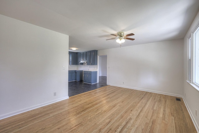 unfurnished living room with hardwood / wood-style floors and ceiling fan