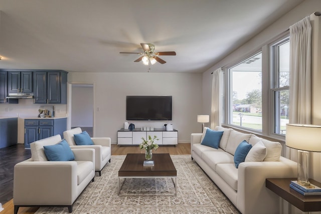 living room featuring ceiling fan and light hardwood / wood-style floors