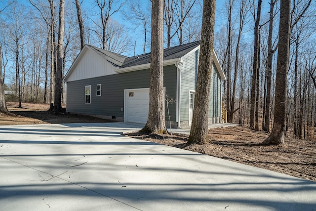 view of property exterior with a garage and driveway