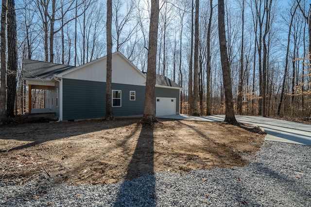 view of side of property featuring crawl space, driveway, and a garage