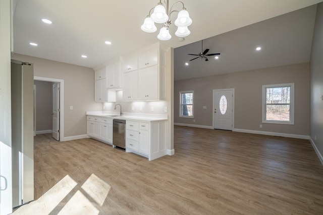 kitchen with a barn door, white cabinets, plenty of natural light, and a sink