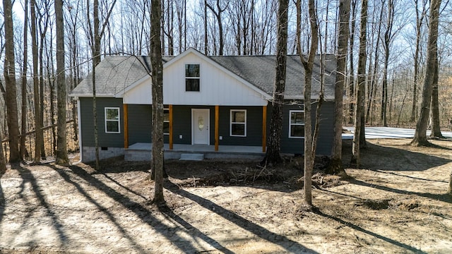 view of front of home with crawl space, covered porch, and a shingled roof