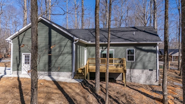 rear view of house with a deck and a shingled roof