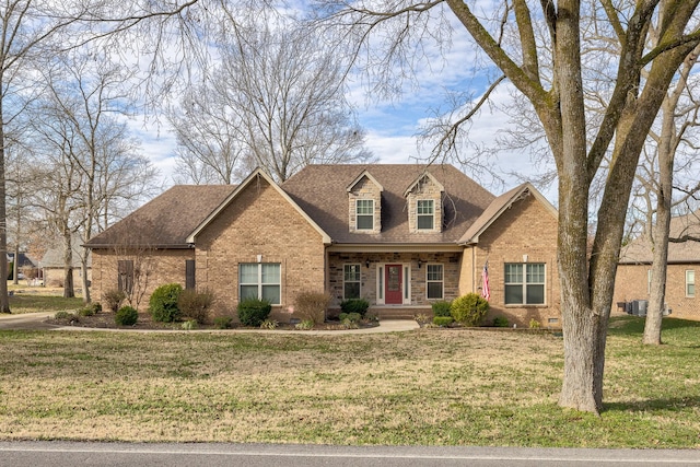 new england style home featuring a front lawn